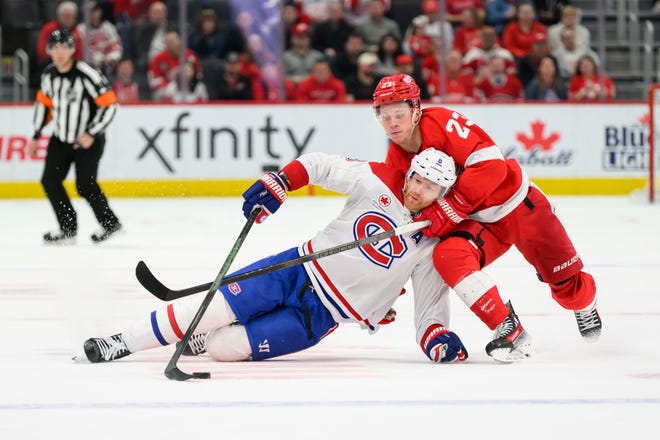 Detroit left wing Lucas Raymond and Montreal defenseman Mike Matheson battle for the puck during the overtime period.