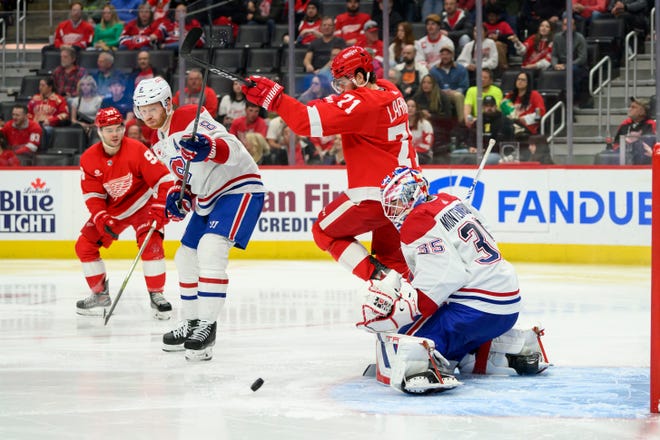Detroit center Dylan Larkin tries to deflect the puck past Montreal goaltender Sam Montembeault during the third period.