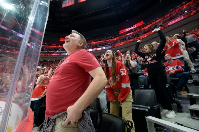 Red Wings fans celebrate after Detroit left wing Lucas Raymond scored the game tying goal during the third period.