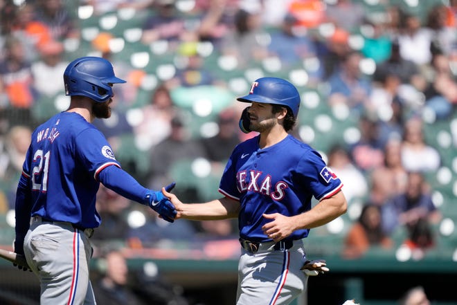 Texas Rangers' Josh Smith is greeted by Jared Walsh (21) after scoring from third on a single by designated hitter Ezequiel Duran during the fifth inning.
