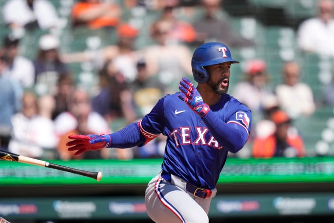 Texas Rangers' Marcus Semien connects for a RBI single to center during the fifth inning.