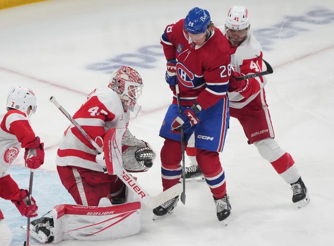 Detroit Red Wings goaltender James Reimer (47) makes a save against Montreal Canadiens' Christian Dvorak (28) as Red Wings' Shayne Gostisbehere (41) defends during the first period of an NHL hockey game Tuesday, April 16, 2024, in Montreal. The Red Wings win, 5 to 4 in OT.