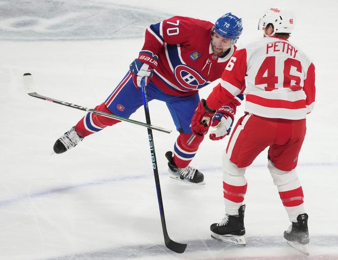 Detroit Red Wings' Jeff Petry (46) breaks his stick as he works against Montreal Canadiens' Tanner Pearson (70) during the first period.