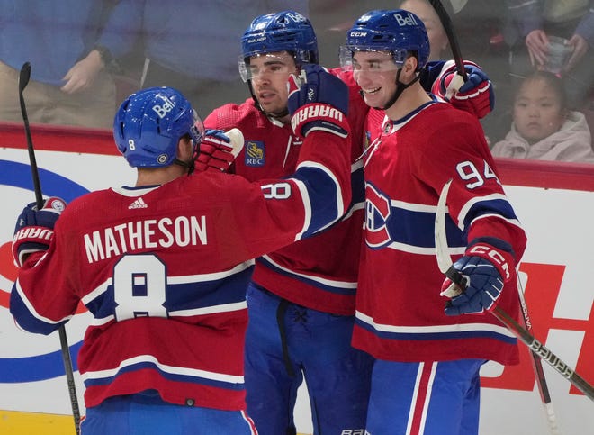 Montreal Canadiens' Alex Newhook (15) celebrates his goal against the Detroit Red Wings with Logan Mailloux (94) and Mike Matheson (8) during the first period.