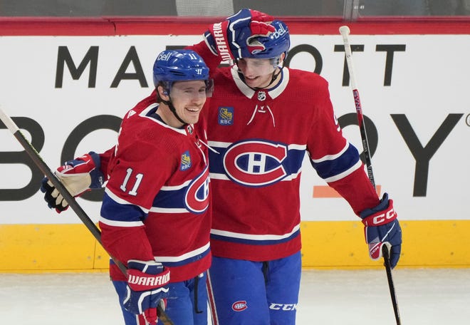 Montreal Canadiens' Logan Mailloux (94) is congratulated on his first NHL assist by Brendan Gallagher (11), during the first period.