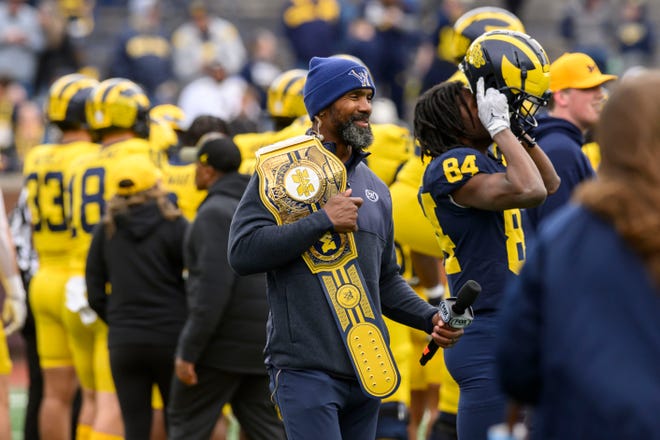 Charles Woodson, former Michigan defensive back and NFL player who is now an analyst for Fox Sports, walks on the field before the start of the annual spring game at Michigan Stadium.