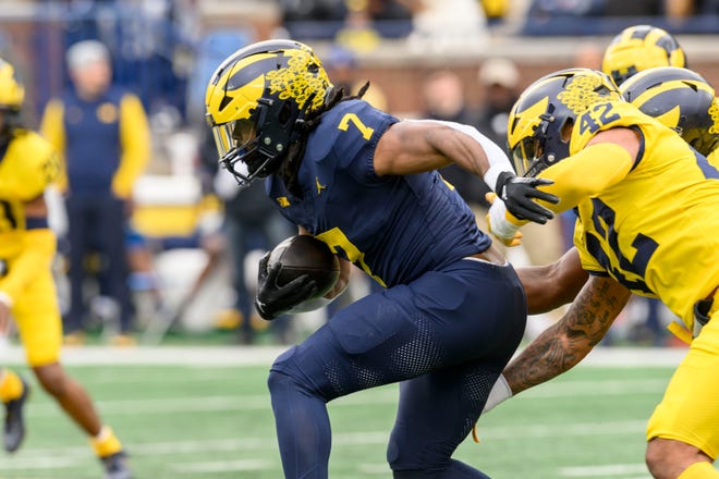Team Blue running back Donovan Edwards runs the ball in the first quarter of the annual spring game at Michigan Stadium.