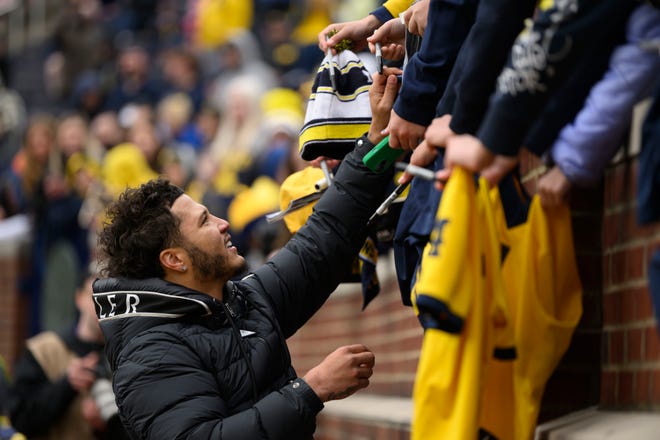 Former Michigan running back Blake Corum signs autographs in the second quarter of the annual spring game at Michigan Stadium.