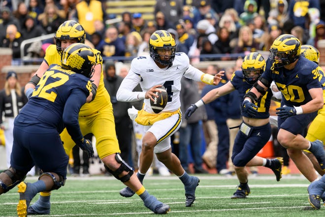 Team Maize quarterback Jayden Denegal looks for an open man in the second quarter of the annual spring game at Michigan Stadium.