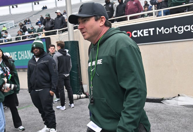 New Michigan State head coach Jonathan Smith makes his way onto the field for the football team's spring showcase/scrimmage at Spartan Stadium.
