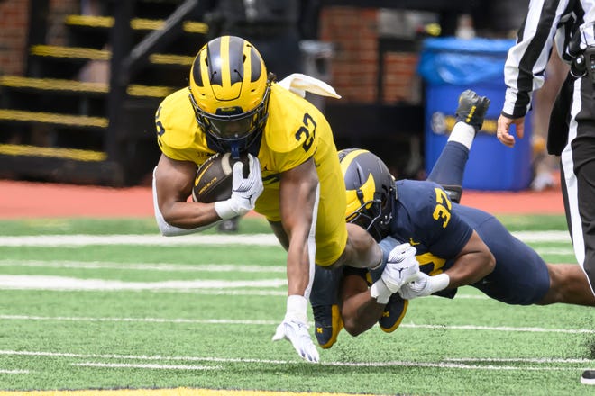 Team Maize running back Tavierre Dunlap is tackled by Team Blue defensive back Shomari Stone in the fourth quarter of the annual spring game at Michigan Stadium.