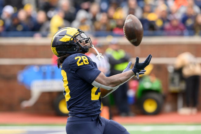 Team Blue running back Benjamin Hall runs back a kick in the fourth quarter of the annual spring game at Michigan Stadium.