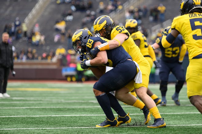 Team Blue tight end Zack Marshall is tackled by Team Maize linebacker Liam Groulx in the fourth quarter of the annual spring game at Michigan Stadium.