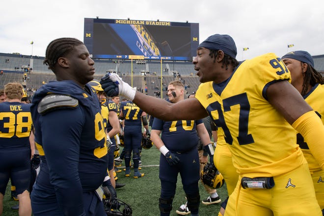 Team Maize’s Chibi Anwunah, right, goofs around with Team Blue defensive lineman Ike Iwunnah after the annual spring game at Michigan Stadium.