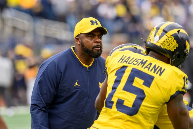 Defensive run game coordinator and linebackers coach Brian Jean-Mary watches his players before the start of the annual spring game at Michigan Stadium.