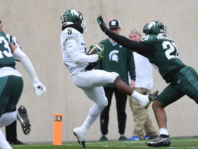 Running back Nathan Carter pulls in a touchdown reception over linebacker Wayne Matthews III during the Michigan State football's spring showcase/scrimmage at Spartan Stadium.