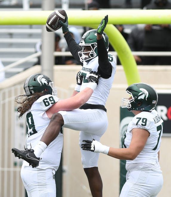 Offensive linemen Jacob Merritt and Mercer Luniewski celebrate receiver Nick Marsh’s touchdown during the Michigan State football's spring showcase/scrimmage at Spartan Stadium in East Lansing on Saturday, April 20, 2024.