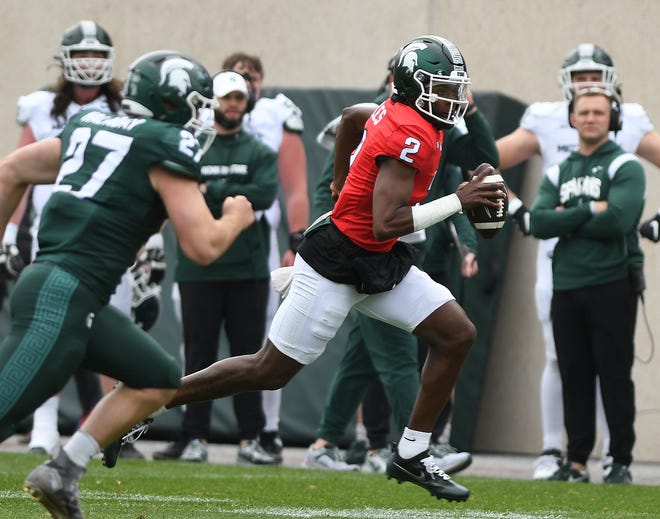 Quarterback Aidan Chiles beaks out of the pocket and heads upfield during the Michigan State football's spring showcase/scrimmage at Spartan Stadium.