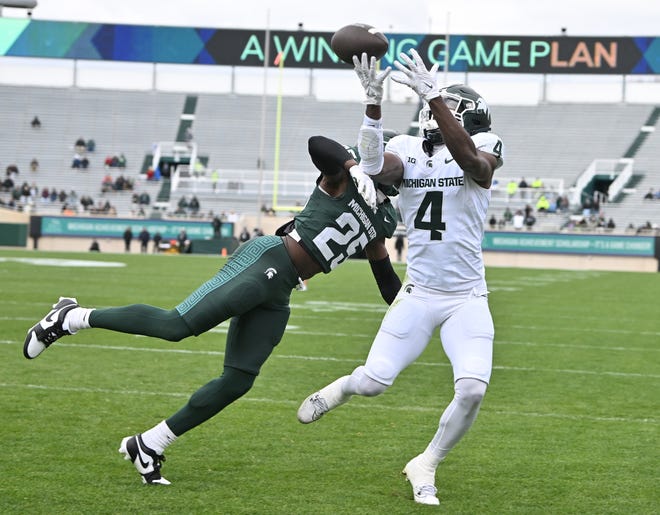 Defensive back Chance Rucker breaks up a reception by wide receiver Jaron Glover in the end zone during the Michigan State football's spring showcase/scrimmage at Spartan Stadium.