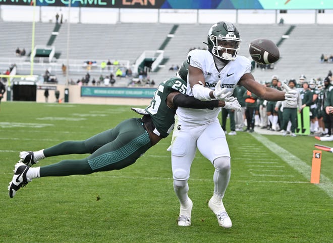 Defensive back Chance Rucker breaks up a reception by receiver Jaron Glover in the end zone during the Michigan State football's spring showcase/scrimmage at Spartan Stadium.