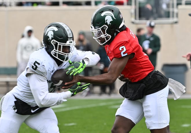Running back Nathan Carter takes the handoff from quarterback Aidan Chiles during Michigan State football's spring showcase/scrimmage at Spartan Stadium in East Lansing, Michigan on April 20, 2024.