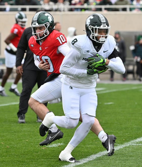 Running back Jalen Berger takes the handoff from quarterback Tommy Shuster during the Michigan State football's spring showcase/scrimmage at Spartan Stadium in East Lansing, Michigan on April 20, 2024.