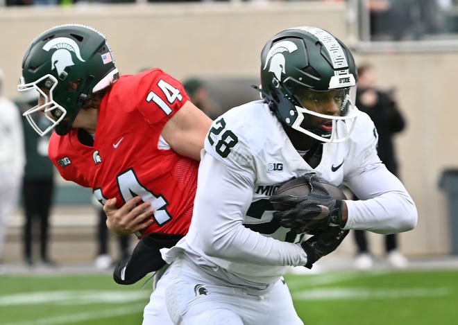 Running back Brandon Tulles takes the handoff from quarterback Alessio Milivojevic at Michigan State football's spring showcase/scrimmage at Spartan Stadium in East Lansing, Michigan on April 20, 2024.