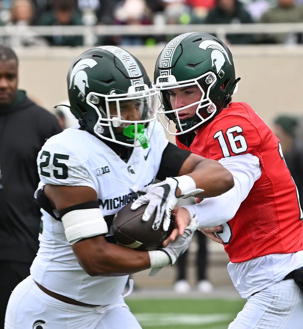 Running back Joseph Martinez takes the ball from quarterback Ryland Jessee at Michigan State football's spring showcase/scrimmage at Spartan Stadium in East Lansing, Michigan on April 20, 2024.