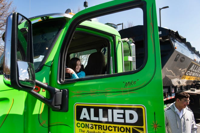 Aliza Roberg of New Jersey takes a seat inside a construction truck during a free Touch-a-Truck event hosted by the Southfield Parks & Recreation Department on Sunday, April 21, 2024 at the Southfield Municipal Complex.