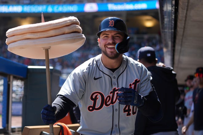 Detroit Tigers' Buddy Kennedy celebrates in the dugout after hitting a two-run home run during the third inning.