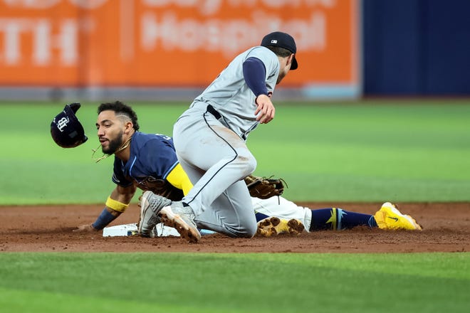 Jose Caballero #7 of the Tampa Bay Rays slides past a tag from Colt Keith #33 of the Detroit Tigers to steal second base during the third inning.