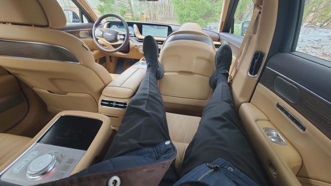 Detroit News critic Henry Payne relaxes in the Barcalounger-like rear seat of the 2024 Genesis G90.