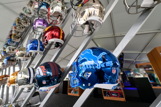 A wall of NFL helmets sits on display at the NFL Draft experience, at Hart Plaza, in Detroit, April 24, 2024.