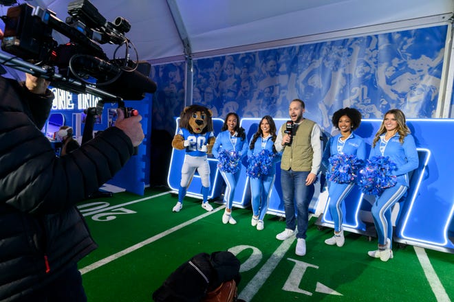 German television reporter Jonas Hoffmeister films a segment from inside the Detroit Lions Fan Experience Activation at the NFL Draft experience, at Hart Plaza, in Detroit, April 24, 2024.