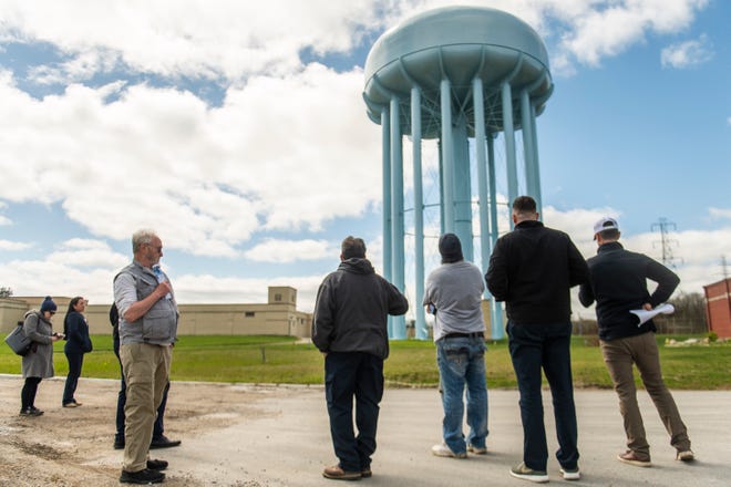 Flint Water Plant Supervisor Scott Dungee, center, explains how the water tower operates while giving a public tour of the plant on Wednesday, April 24, 2024 in Flint.