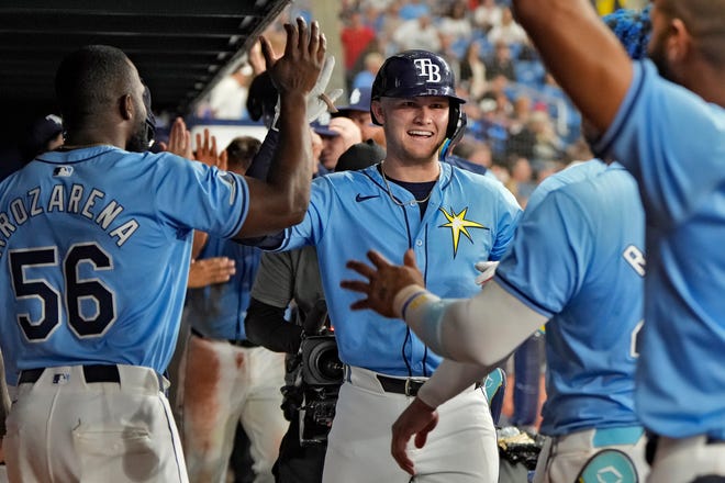 Tampa Bay Rays' Curtis Mead, of Australia, center, celebrates in the dugout after his two-run home run off Detroit Tigers relief pitcher Will Vest during the sixth inning.