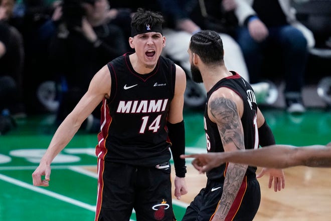 Heat guard Tyler Herro (14) celebrates with Caleb Martin late in the second half of Game 2 against the Celtics on Wednesday in Boston.
