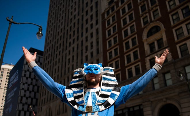 Jacob Sloboda of Gaylord poses for a portrait wearing his hand-painted Egyptian-style Detroit Lions mask while walking towards the NFL Draft Experience with friends on Thursday, April 25, 2024 in downtown Detroit.