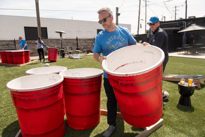 Ben Crowgey of Ohio returns a large barrel to its starting position after playing a game of jumbo beer pong on the patio at The Yard in Detroit's Corktown on Friday, April 26, 2024.