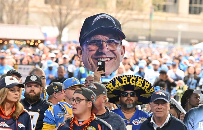 A cutout of former Michigan coach Jim Harbaugh, now head coach of the Chargers, in the crowd at the 2024 NFL Draft in Detroit.