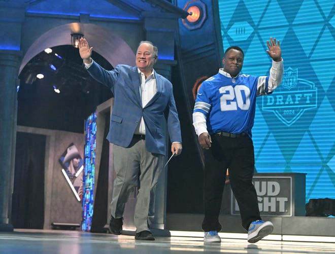 Detroit Mayor Mike Duggan and NFL Hall of Fame running back Barry Sanders come out to announce the Lions' pick in the second round of the 2024 NFL Draft in Detroit.