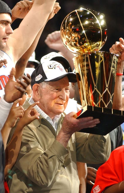 Pistons owner Bill Davidson hoists the NBA championship trophy after the Pistons won Game 5 of the NBA Finals against  the Los Angeles Lakers on June 15, 2004.