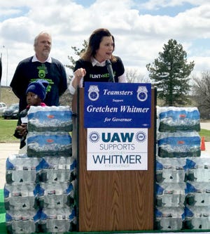 Gretchen Whitmer campaigns in Flint on April 28, 2018, and helps with a bottled water distribution.