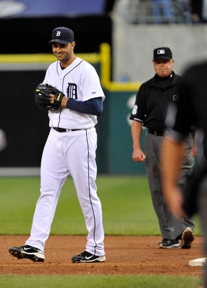 Tigers pitcher Armando Galarraga walks away from first-base umpire Jim Joyce (right) moments after Joyce's call denied him a perfect game. Joyce later admitted he had blown the call.