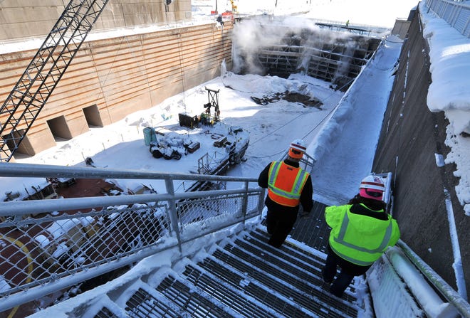 U.S. Corps of Engineers chief of maintenance Jeff Harrington, left, and chief of operations LeighAnn Ryckeghen walk down into the Poe Lock Tuesday, March 12, 2019.