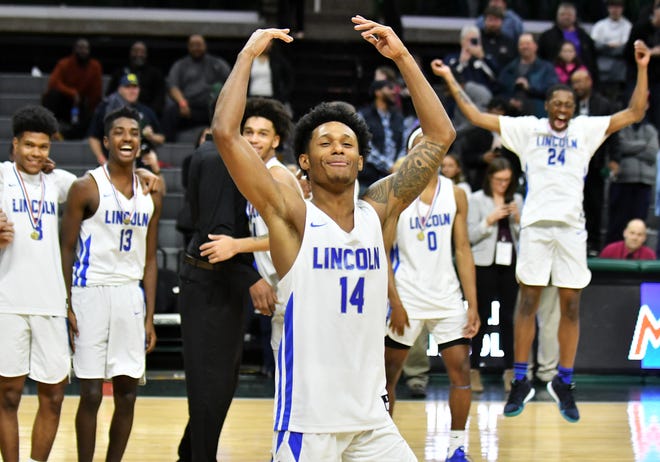 Lincoln guard Jalen Fisher celebrates after the game.