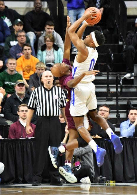 U-D Jesuit's Caleb Hunter (2) defends a shot by Lincoln guard Tahj Chatman (0) in the second half.