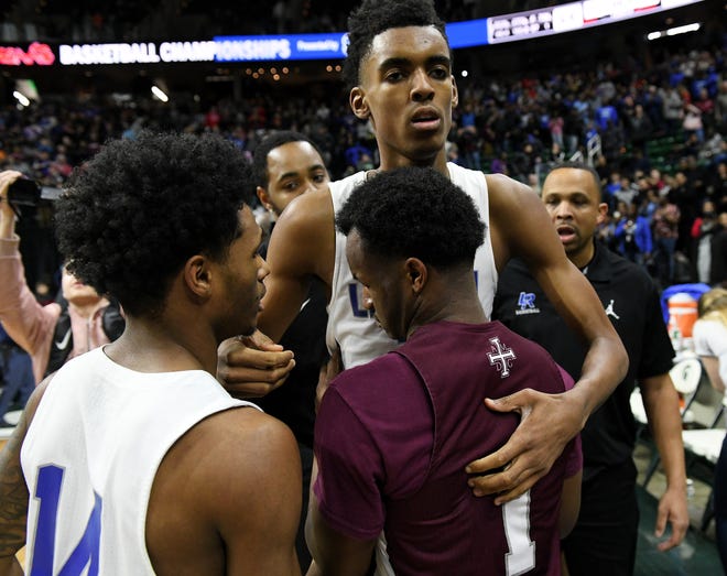 U-D Jesuit's Julian Dozier (1) comes over for the postgame handshake with Lincoln's Emoni Bates.