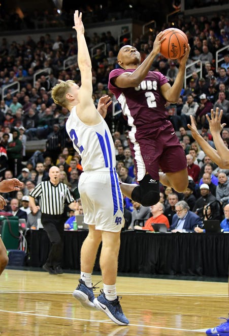 Lincoln guard Cameron Johnson defends a shot by U-D Jesuit's Caleb Hunter in the first half.