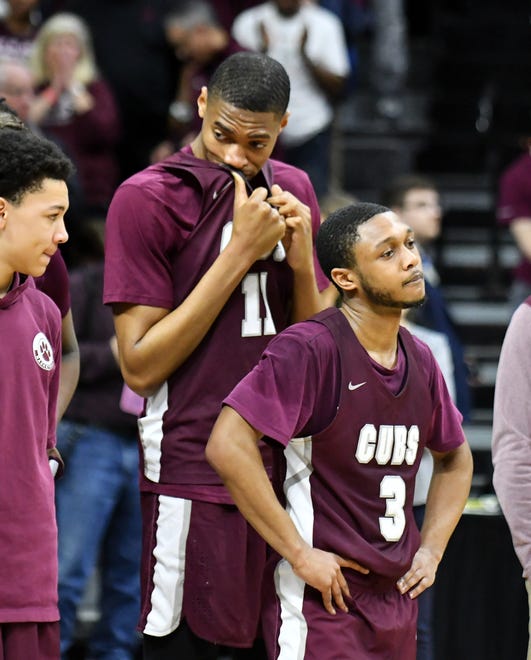 U-D Jesuit's Jalen Thomas (11) and Jordan Montgomery about to receive the runner-up trophy after the game.